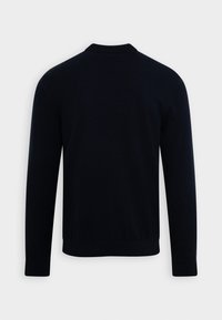 Svart långärmad tröja med ribbad nederdel och ärmmuddar, visad platt bakifrån på en vit bakgrund.