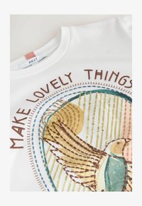 Neselectat, white embroidered bird graphic