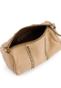 Tan leather crossbody bag with a zip closure, featuring bronze studs along the seam, textured surface, and a soft, rounded shape.