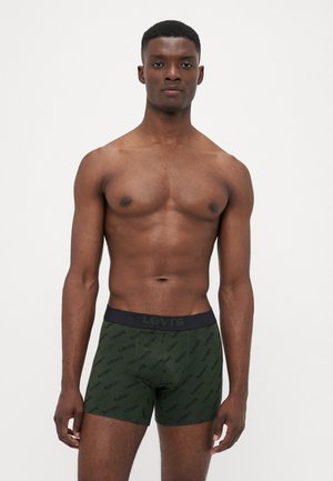 Boxer shorts verdi con un elastico nero in vita, caratterizzati da un motivo con il logo "Levi's" ripetuto. Design in tessuto liscio e elastico.