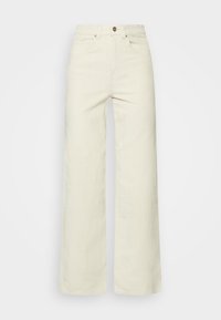 Leveälahkeiset kermaiset farkut, jotka on valmistettu teksturoidusta kankaasta ja joissa on korkeavyötärö, etutaskut ja yksittäinen napitus.