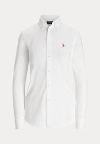 Camicia bianca a maniche lunghe con bottoni, colletto abbottonato e piccolo logo ricamato di un giocatore di polo sul petto sinistro.