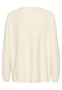 Cremefarbenes, übergroßes Sweatshirt aus weichem Strickmaterial, mit weiter Halslinie, gesenkten Schultern und langen Ärmeln.