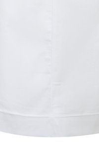 Weißer Baumwollstoff mit glatter Textur, der eine saubere Naht und einen gefalteten Saum am unteren Ende zeigt und Einfachheit im Design betont.