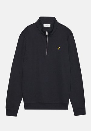 Schwarzer Zip-Up-Sweatshirt mit hohem Kragen, der ein kleines gelbes Vogel-Logo auf der linken Brust und gerippte Bündchen und Saum aufweist. Weiche Textur.