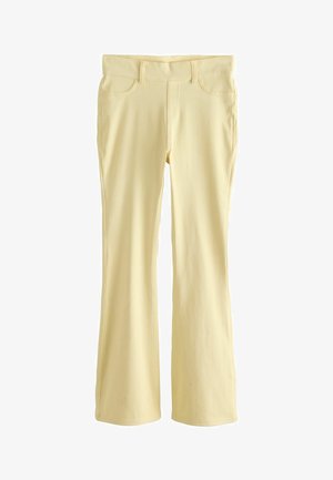 Svetložlté bootcut nohavice s prednými vreckami a priliehavým pásom, zobrazené rozložené na bielom pozadí.