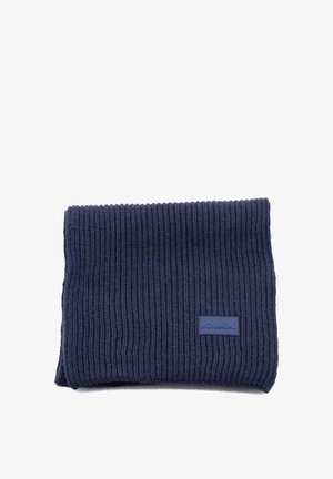 Sciarpa blu navy lavorata a maglia con trama a coste. Presenta una forma rettangolare e una patch con il logo ALY in blu. Materiale morbido, adatto per il calore.