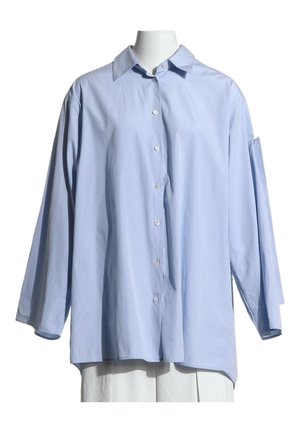 Light blue oversized button-up shirt with long sleeves and a standard collar displayed on a headless mannequin.