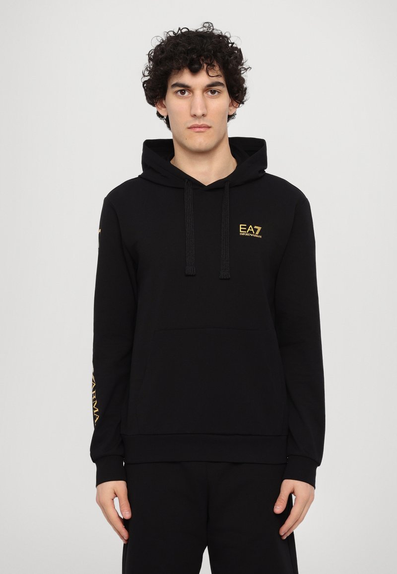 Black hooded sweatshirt made of soft fabric, featuring a kangaroo pocket, drawstrings, and gold EA7 logo on the chest and sleeve.