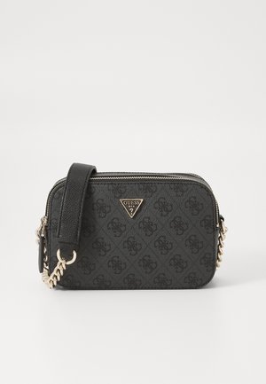 Sac bandoulière noir Guess avec motif monogramme, bandoulière chaîne dorée et plaque logo triangulaire à l'avant, forme rectangulaire avec fermeture éclair.