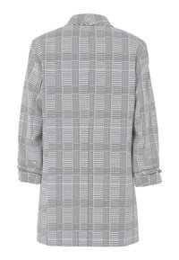 Blazer à carreaux noir et blanc avec un col classique et des manches longues, vu de dos sur un fond blanc.