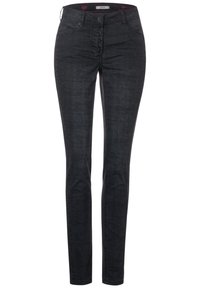Jean skinny noir avec un motif texturé, fermeture avant à cinq boutons et poches traditionnelles pour un usage pratique.
