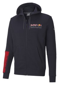 Marinblå zip-up hoodie av mjukt tyg med en kanguruficka. Har Red Bull Racing-logotypen framtill och röda detaljer på ärmen.