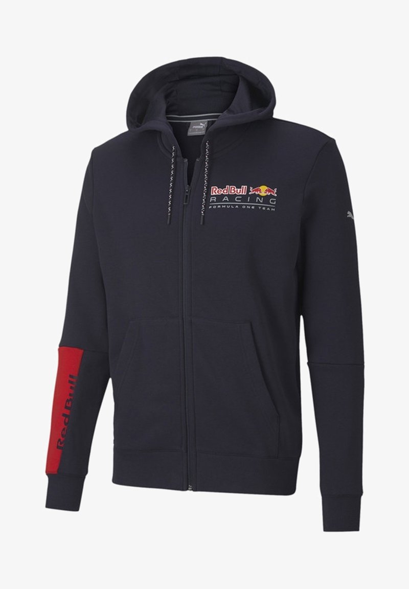 Marinblå zip-up hoodie av mjukt tyg med en kanguruficka. Har Red Bull Racing-logotypen framtill och röda detaljer på ärmen.