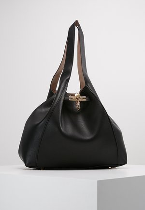 Musta nahkalaukku, jossa on tekstuuripinta, tilava muotoilu ja kaksi pitkää kantohihnaa. Varustettu kultaisella metalliosalla, jossa on ketjukiinnitys.