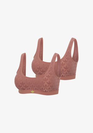 Deux brassières de sport roses avec des motifs de feuilles embossés et un logo Adidas vert néon sur la bande frontale, présentées sous les angles avant, côté et arrière.