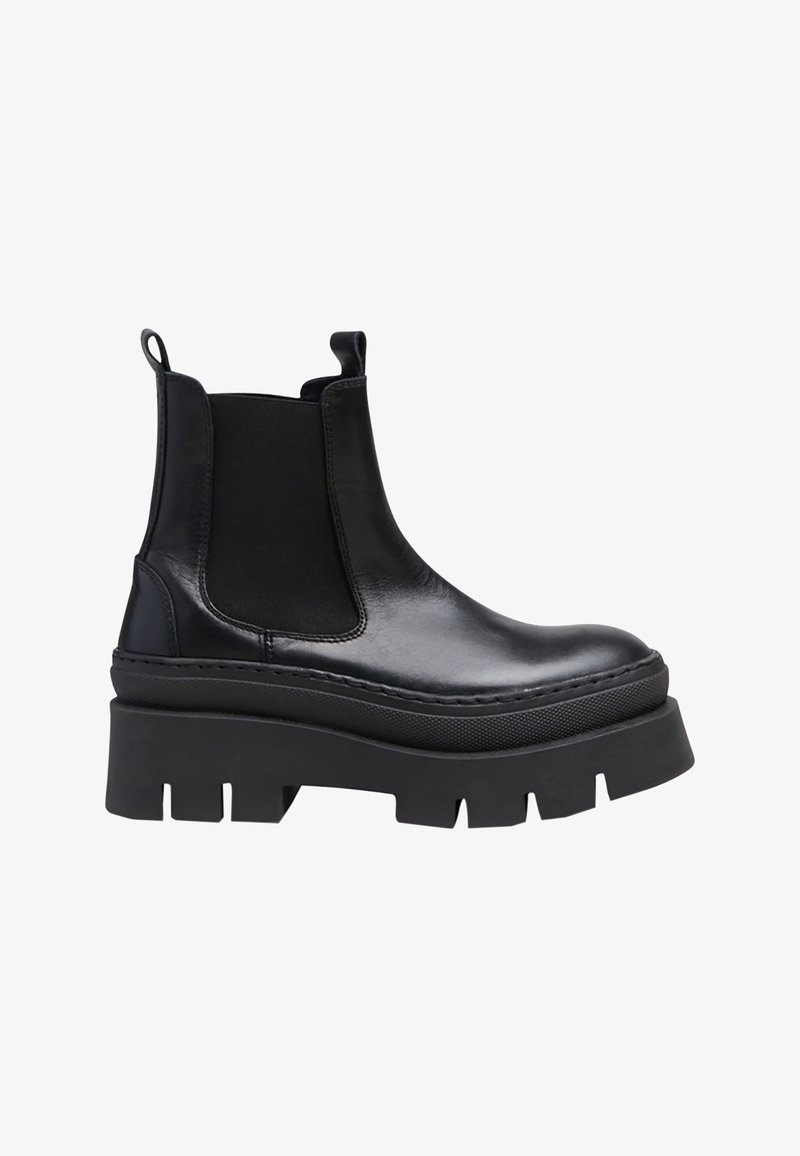 Botas Chelsea de cuero negro con paneles elásticos a los lados, suela de plataforma gruesa y costuras reforzadas en las costuras.