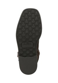 Suola di scarpa in gomma nera con pattern di grip texturizzato, punta arrotondata e bordi lisci. Presenta un marchio in rilievo vicino al tallone.