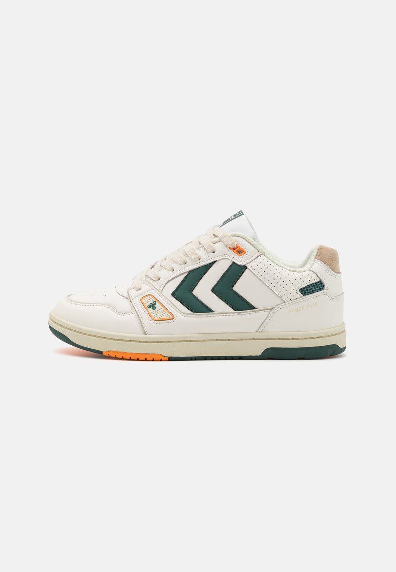 Sneaker with a white leather upper, green accents, and orange detailing; features perforated sides, prominent chevron logo, and a rubber sole.