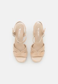 Beige suede heeled sandals with peep-toe design, cross straps, side buckle closure, and glossy patent finish on the sole. Size 37.