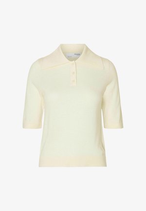 Trumpas rankovėmis polo marškinėliai šviesiai kreminės spalvos, su smailiu apykaklė ir trimis mygtukais. Lygus mezgimo tekstūra, paprastas dizainas be raštų.