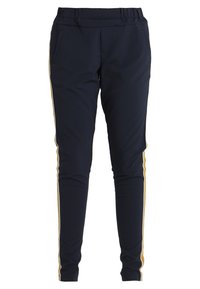 Pantalons marine avec taille élastique, deux poches latérales et bandes dorées sur les côtés. Fabriqués en tissu extensible, avec une coupe ajustée.