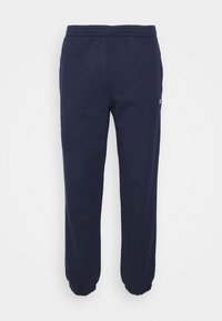 Navy blue sweatpants made of soft fabric, featuring an elastic waistband and cuffed ankles. Includes a small logo detail on the side.