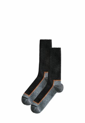 Schwarze gerippte Socken mit kontrastierendem grauem Zehen- und Fersenbereich. Ein orangefarbenes Akzentband verläuft entlang der Seiten und sorgt für einen auffälligen Detail.