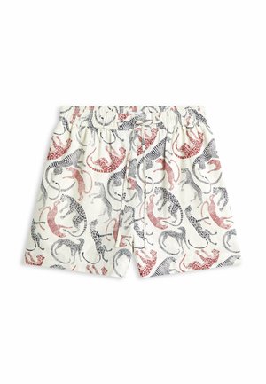 Shorts à taille élastique blanche avec des motifs léopard rouges et noirs dispersés sur le tissu.