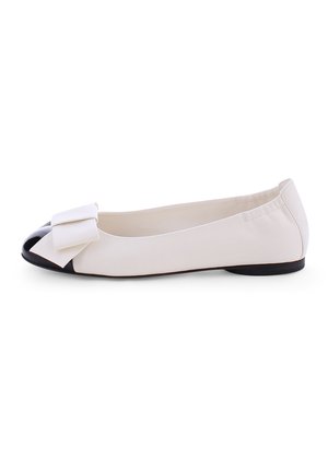 White ballet flat shoe with a black cap toe and bow accent at the front. Smooth material and a low, rounded heel.