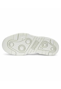 White sneaker sole with textured rubber, featuring circular grooves, a central pattern, and embossed "PUMA" branding.
