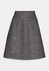 Jupe taille haute en ligne A avec tissu texturé noir et blanc moucheté et subtil motif chevrons diagonaux.