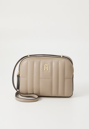 Beige crossbody bag with quilted pattern and gold hardware. Features a black accent trim and a detachable strap for versatility.