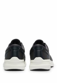 Baskets bleues en cuir et maille, dotées de semelles blanches, d'accents contrastés et du logo de la marque sur le talon.