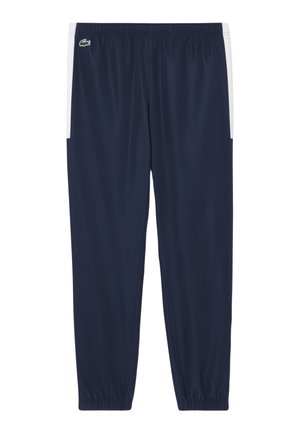 Navy blue sports pants with an elastic waistband, side white accents, and a small green logo. Made of smooth, lightweight fabric.