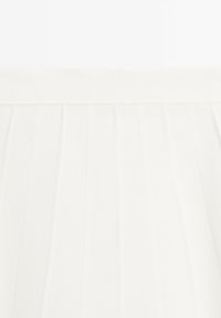 White pleated skirt featuring a smooth texture, elastic waistband, and precise vertical folds, creating a clean and uniform appearance.