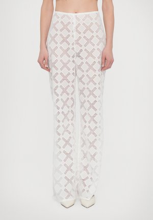 White, textured, wide-leg pants featuring a geometric diamond pattern. Fabric is sheer and semi-transparent with a soft finish.