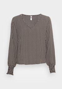 Blouse marron avec un col en V et des manches longues. Présente un motif texturé de zigzags blancs et crème. Les poignets smockés ajoutent un détail.