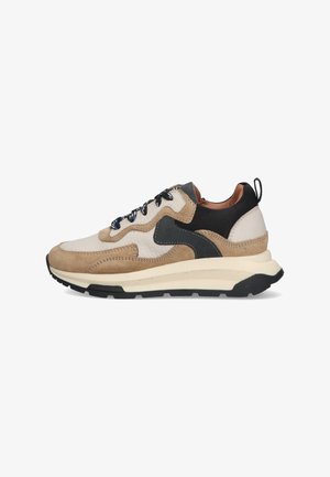 Beige and black sneakers with suede and leather materials, textured midsole, round toe, and decorative stitching details.