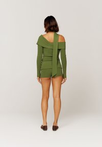 Sweter w kolorze oliwkowej zieleni wykonany z prążkowanego dzianiny, z odkrytymi ramionami, długimi rękawami i ozdobnym kołnierzem; w komplecie z dopasowanymi szortami.