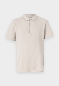 Lys beige kortærmet polo skjorte med lynlås krave, tekstureret stof og sidelæg. Har et subtilt ribbet mønster.