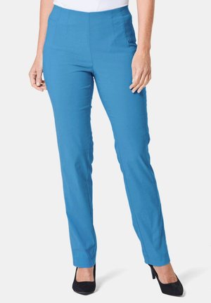 Pantalons de yoga bleus avec une texture lisse, taille haute et design ajusté. Présente des plis avant subtils et des poches latérales.