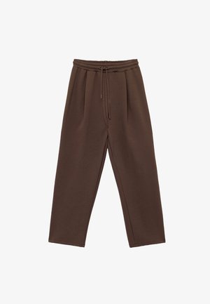 Ruske, brede bukser laget av mykt materiale, med elastisk midje og snor, samt to forkne folder for ekstra detaljer.