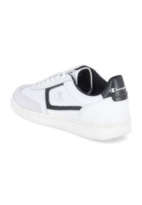 Adidași albi cu accente negre, piele perforată, detalii din microsuede și talpă din cauciuc plat. Prezintă logo pe lateral și pe călcâi.
