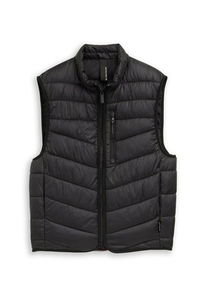 Fekete pufi mellény cipzáros elülső résszel, magas gallérral és V-alakú steppelt mintával. Simább, könnyű anyagból készült, oldal- és mellzsebekkel.