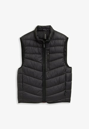 Musta toppaliivi, jossa vetoketju edessä, korkea kaulus ja chevron-tikkikuvio. Sileä, kevyt kangas, jossa sivu- ja rintataskut.