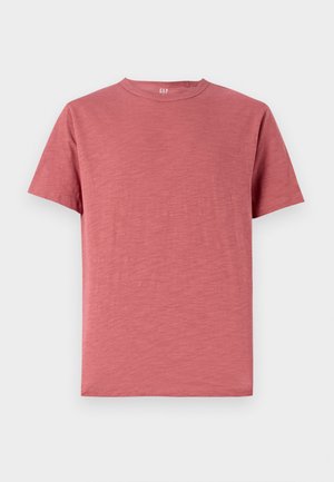 Lühikeste varrukatega, ümmarguse kaelusega t-särk tuhmroosa värviga, valmistatud pehmest puuvillakangast, millel on sile tekstuur ja lihtne disain.