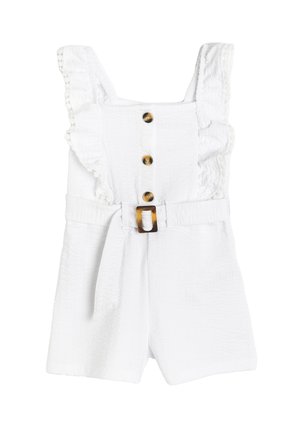 Rompers blanc avec des bretelles à volants, cinq boutons décoratifs marron et une ceinture avec une boucle en écaille de tortue. Tissu texturé.
