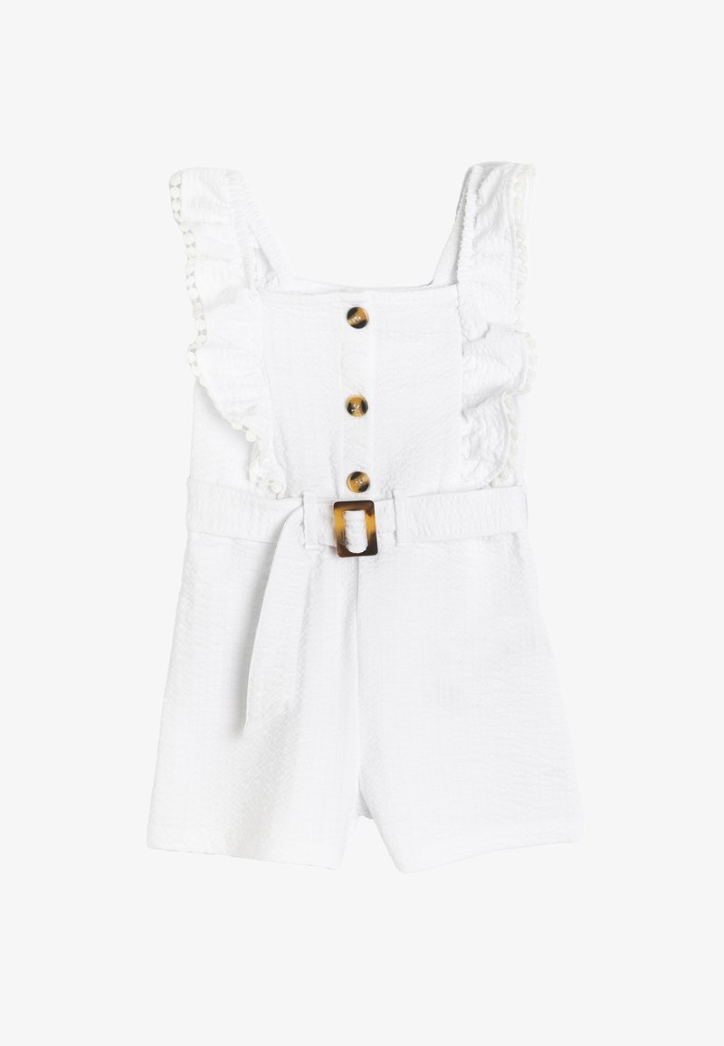 White romper with ruffled shoulder straps, five brown decorative buttons, and a belt featuring a tortoiseshell buckle. Textured fabric.