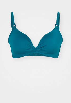 Soutien-gorge rembourré turquoise au toucher lisse. Doté d'un design à l'avant tordu, de bretelles ajustables et d'une fermeture à crochets dans le dos.